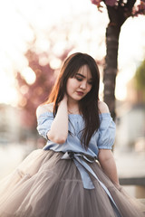 Young Asians girl with modern dress posing in an old Krakow