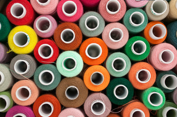 Thread for sewing. Many colorful spools of thread for sewing, colorful background