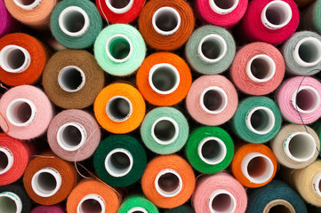 Thread for sewing. Many colorful spools of thread for sewing, colorful background