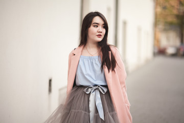 Obraz premium Young Asians girl with modern dress posing in an old Krakow