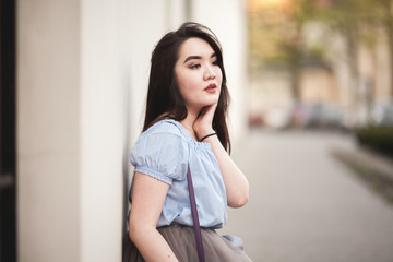 Young Asians girl with modern dress posing in an old Krakow