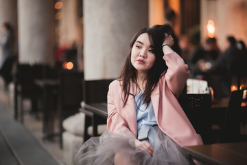 Beautiful Asian girl model in dress sitting at the old city background
