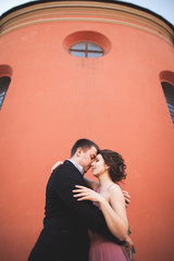 Elegant beautiful wedding couple posing near a church. Krakow