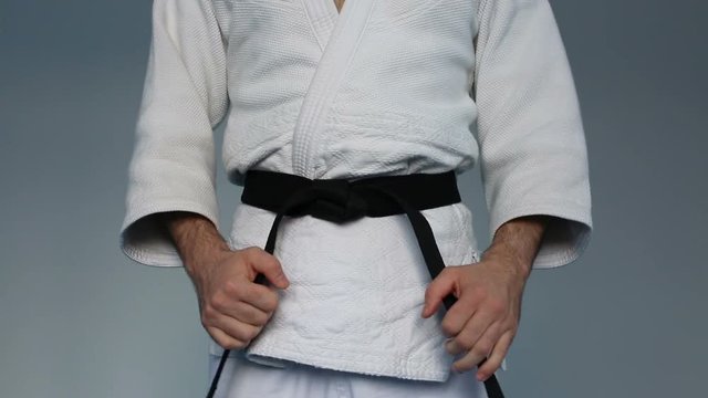Martial arts Master tightening black belt