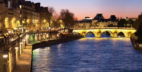 Paris, panorama along Seine river towards illuminated Pont Neuf - obrazy, fototapety, plakaty