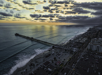Cloudy aerial sunset at the pier. Oceanside, California, USA. Oceanside is 40 miles North of San Diego, California, USA.
