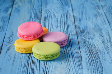 Tasty french macarons on a blue wooden table