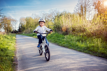 Fototapeta premium Boy learning to ride his bike