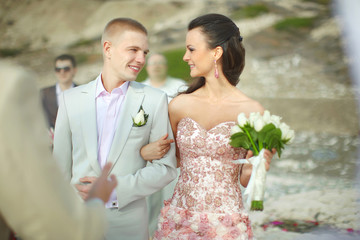 Young, sexy and attractive smiling during ceremony at sandy beac