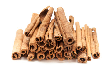 Top front Pile of Raw Organic Cinnamon sticks (Cinnamomum verum) isolated on white background.