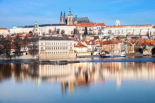 Charles Bridge, St. Vitus Cathedral and other historical buildings in Prague reflected in the river