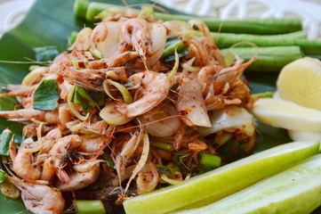 prawn spicy salad with herb on fresh banana leaf