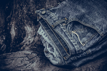 Blue jeans on old wooden background