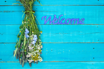 Dried flowers hanging by welcome sign