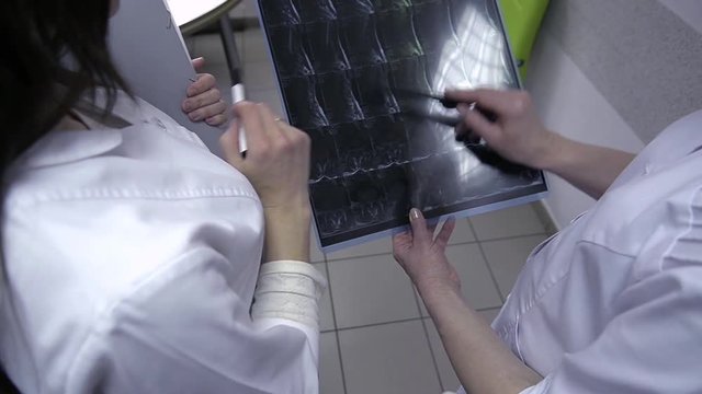 Two doctors with x-ray prints