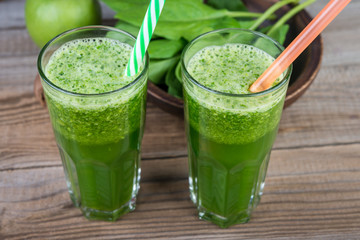 Healthy spinach smoothie on wooden rustic background