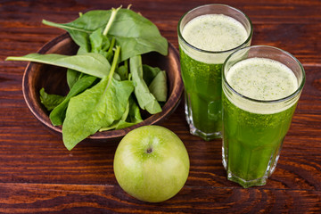 Healthy spinach smoothie and apple  on wooden rustic background