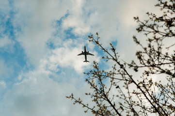 airplane flying in the blue sky with clouds