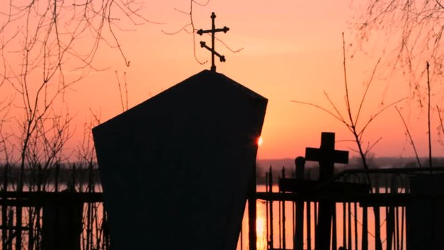 cemetery monument at sunset
