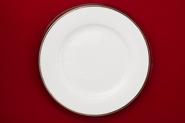 white plate on a red background