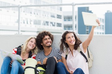 Friends taking selfie on digital tablet