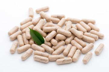Ginkgo biloba capsule on the white background.