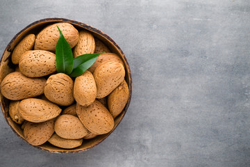 Group of almond nuts with leaves.Wooden background.