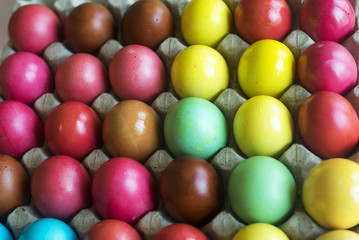 Fototapeta na wymiar Colorful painted eggs in tray for sale.