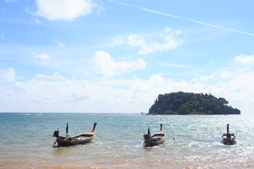 arrange fishing boat at beach harbor island in sunny blue sky
