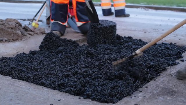 Laying Asphalt In A Pothole