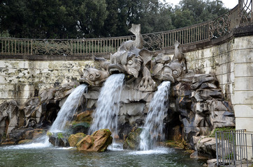 Fototapeta na wymiar dolphin fountain in the park of royal palace of Caserta Italy