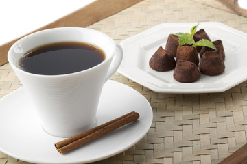 cup of coffee in plate with chocolate candies