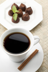 top view black coffee and chocolate candies