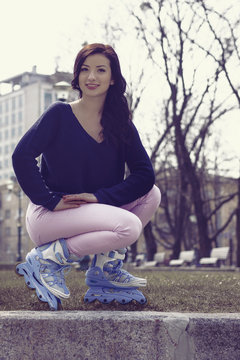 Girl posing wearing a roller skates.