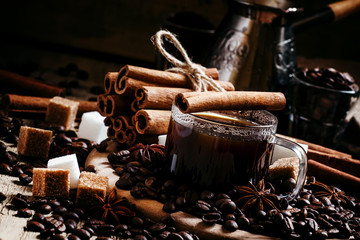 Black sweet coffee with cinnamon and anise, black background, se