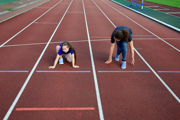 Little girl  with a coach on the stadium