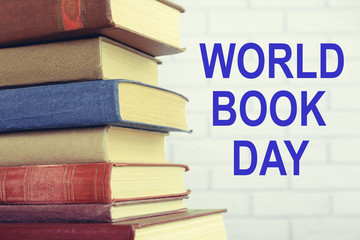 Heap of old books on wooden background. World Book Day poster