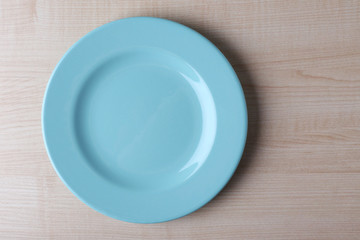 Empty plate on wooden background