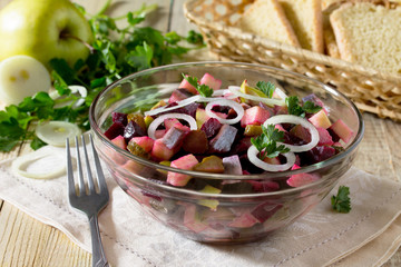 Salad with apple, herring and beetroot, filled with vegetable oi