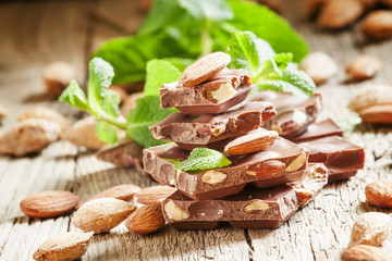 Delicious milk chocolate with whole almonds and mint leaves, vin