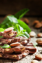 Delicious milk chocolate with whole almonds and mint leaves, vin