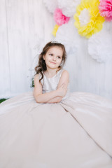 girl in studio sits on a flower background