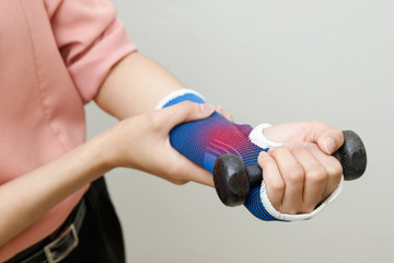 Patient woman doing exercises with dumbbells ,Rehabilitation con