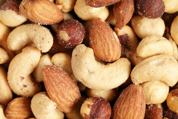salted nut mix background, closeup shallow focus