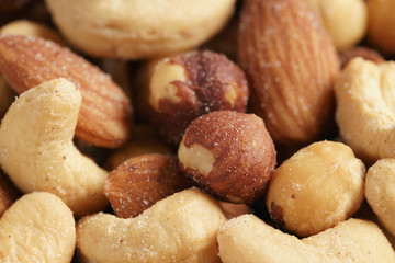 salted nut mix background, closeup shallow focus