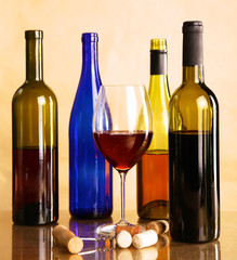 wine bottle and wine glass on a glass table