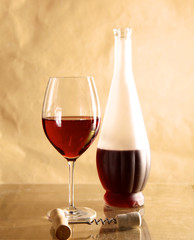 wine bottle and wine glass on a glass table