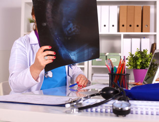 Female doctor at the desk in the office