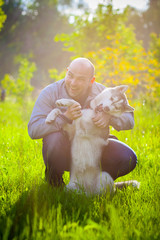 Man and Husky dog in the park.