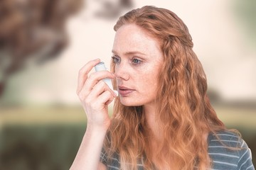 Composite image of beautiful woman using the asthma inhaler